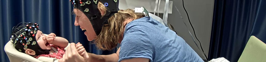 Mother and baby in contact during an EEG surgery